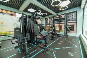 A gym with various exercise machines, a large window, and a view of the outside. - Nested in the Heart of Nairobi, Modern furnished with a safe for your valuables. (Nairobi)