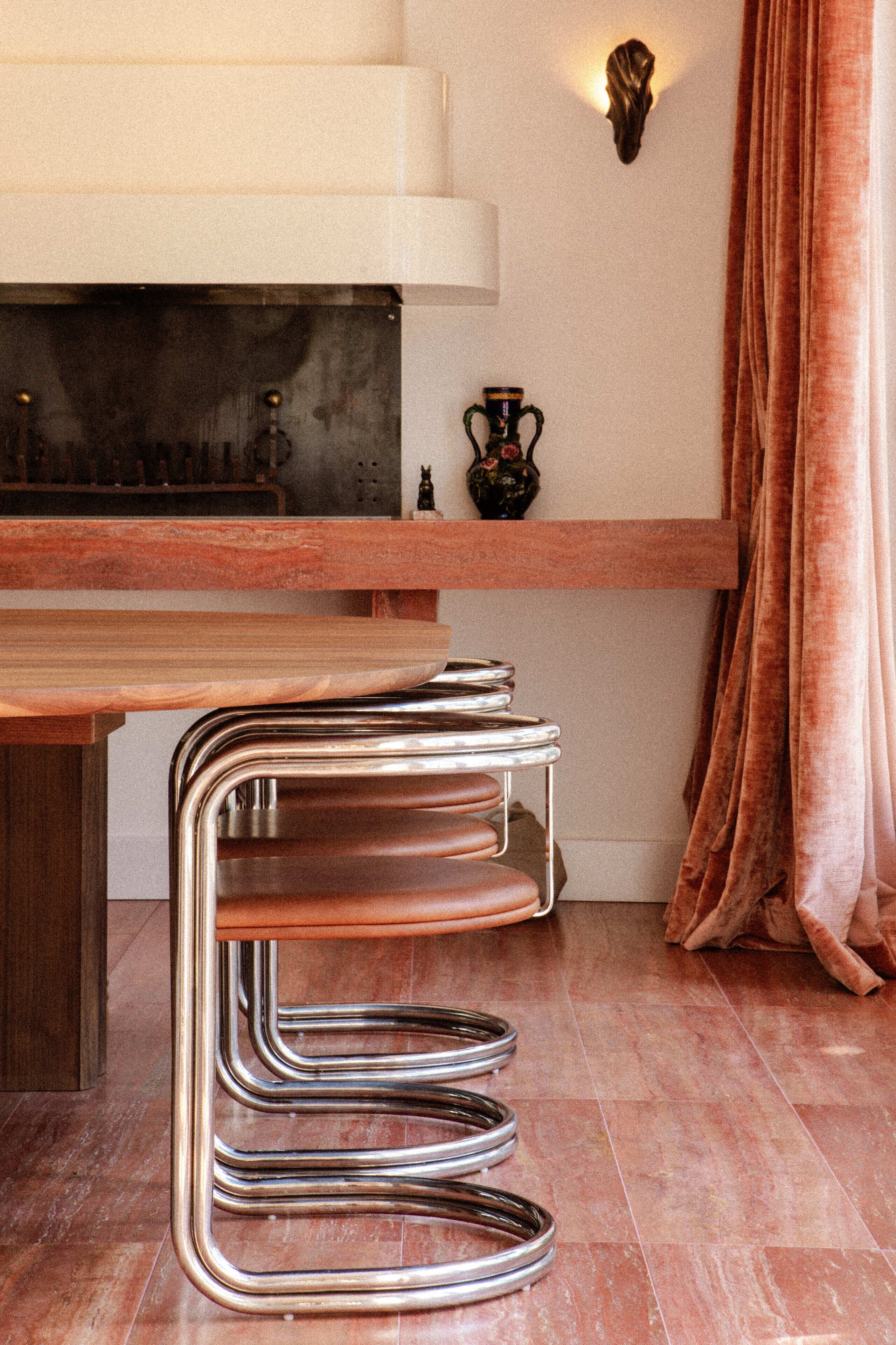 Una cocina con encimera de madera, un taburete de barra de acero inoxidable y un adorno en la pared.