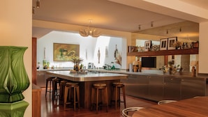 A modern kitchen with a large island, bar stools, and a dining table. - MAISON DOMINOS Villa Pâquerette avec Piscine, Marseille (Marseille)