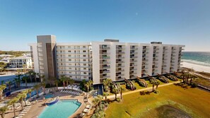 A modern hotel with multiple floors, a pool area, and a beach view. - Beautiful Inside and Out Mainsail 276 (Miramar Beach)
