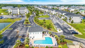 A residential area with a swimming pool, multiple parking lots, and a large building complex. - Carolina Yacht Landing 16 (Little River)
