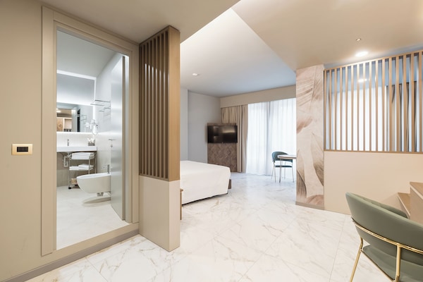 Junior Suite, City View | Minibar, in-room safe, desk, laptop workspace