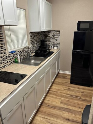 Fridge, microwave, stovetop, coffee/tea maker