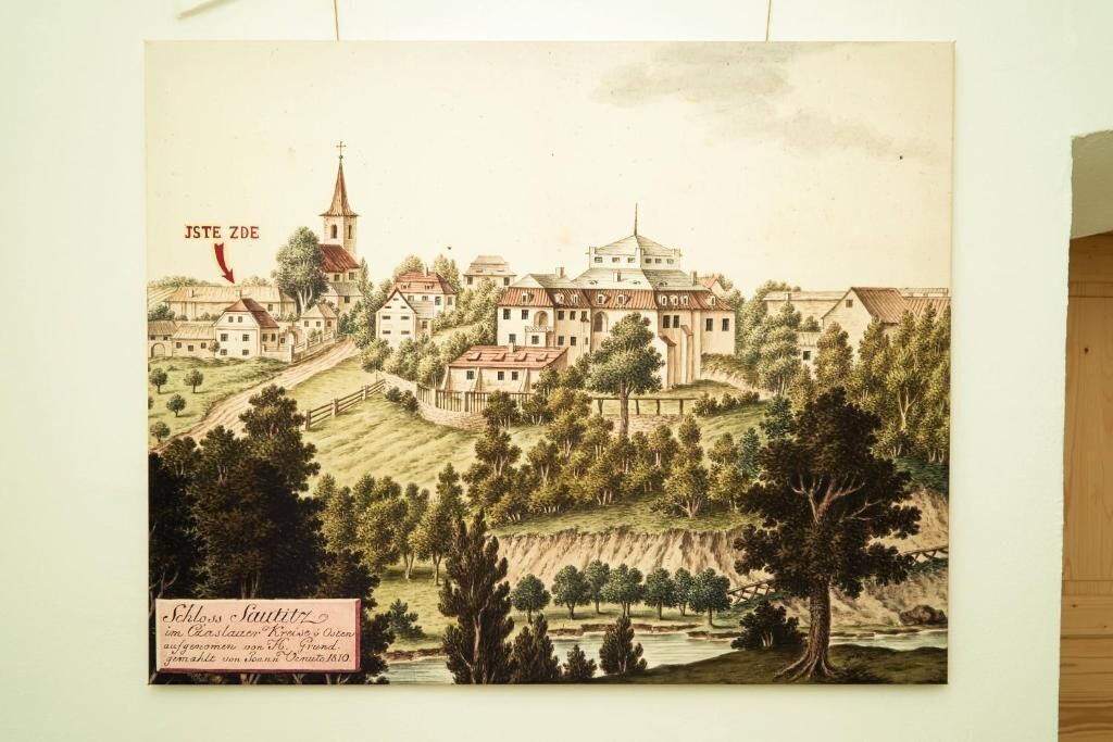 A historical town with a prominent church and surrounding buildings.