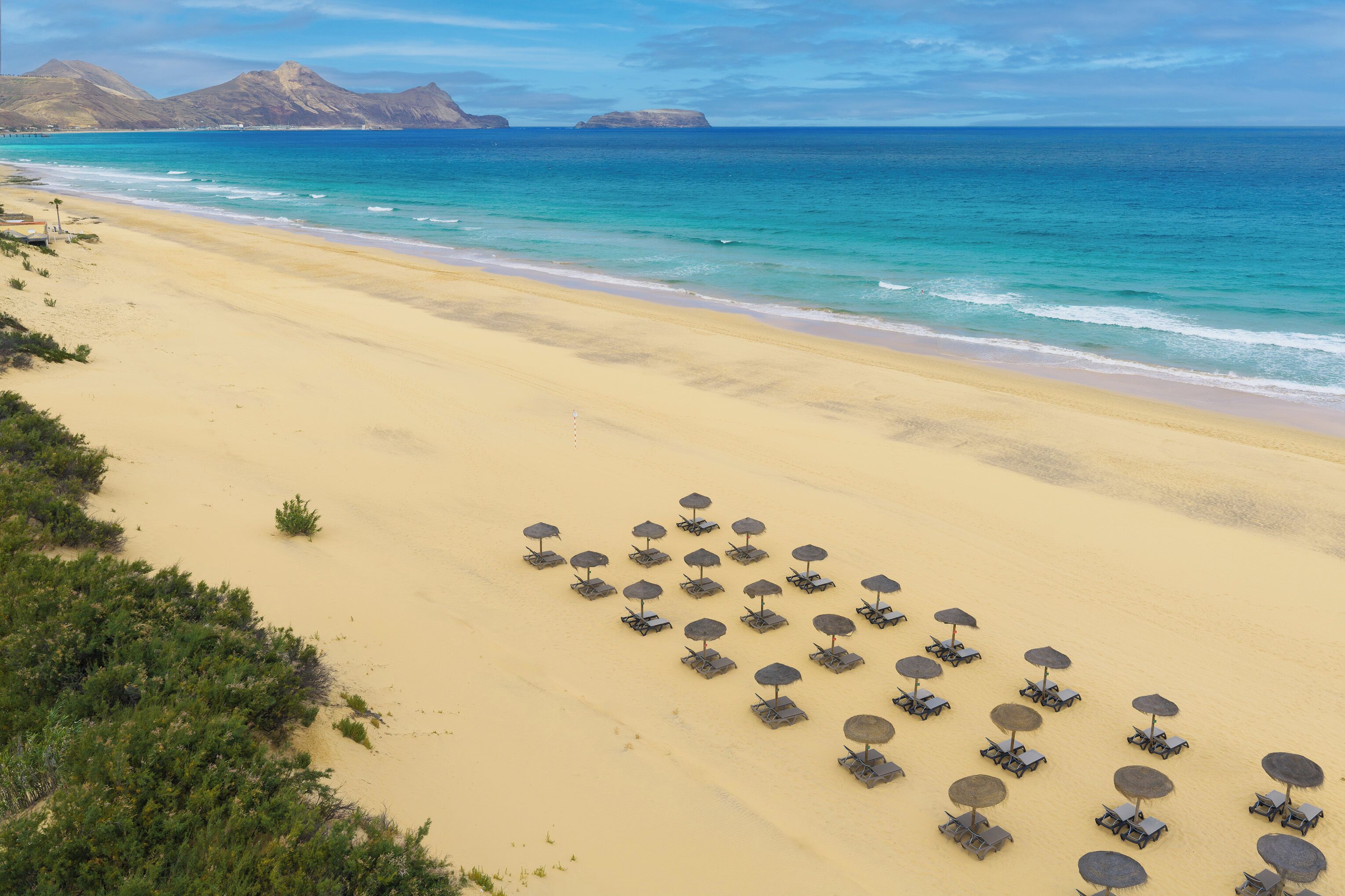 On the beach, white sand, beach towels, beach bar