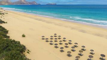On the beach, white sand, beach towels, beach bar