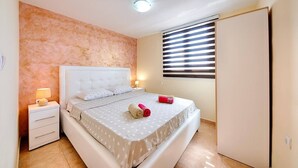 A bedroom with a bed, nightstand, and wardrobe. - Apartman ZIS 5L (Opština Bar)