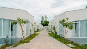 A corridor with modern buildings, each with large windows and a central pathway.