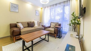 A modern living room with a sofa set, a coffee table, and a side table.
