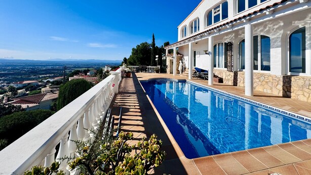 A poolside view of a building with a clear view of the landscape. - Villa Serenity | Private pool, air conditioning, view of the bay of Roses, up to 13 people (El Mas Fumats)