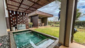 A swimming pool with a wooden deck and a covered seating area. - Luxurious & peaceful blend villa in Royal Park Balaclava Mauritius 2 (Balaclava)