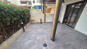 A paved patio area with a stone floor, a wooden post, and a metal bollard. - A family orientated  home to make memories, on the sun soaked island of Cyprus (Tala)