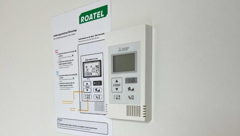 A ROATEL control panel with a digital display and several buttons for temperature and settings.