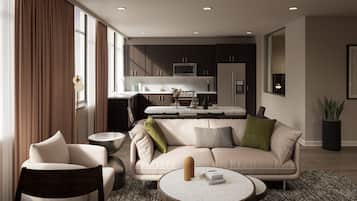 A modern living room with a sofa, coffee table, and a dining area with a kitchen in the background.
