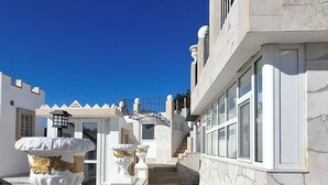 A modern building with a checkered floor, white walls, and a stone facade. - Superior Duplex Apartment for 8 people (Rhodes)