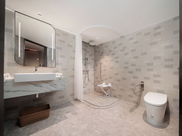 A modern bathroom with a marble sink, a shower with a grab bar, and a toilet. - Hilton Garden Inn Shenzhen Luohu Port (Shenzhen)