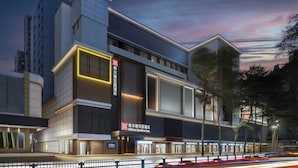 A modern hotel with a prominent entrance, large windows, and a well-lit facade. - Hilton Garden Inn Shenzhen Luohu Port (Shenzhen)