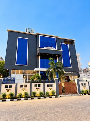 A hotel with a modern facade, large windows, and a prominent sign. - Sapphire The Ganga View  (Prayagraj)