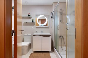 A modern bathroom with a toilet, sink, and shower. - Apartment 'T3 - Sao Pedro 2' with Sea View, Wi-Fi and Air Conditioning (Ponta Delgada)