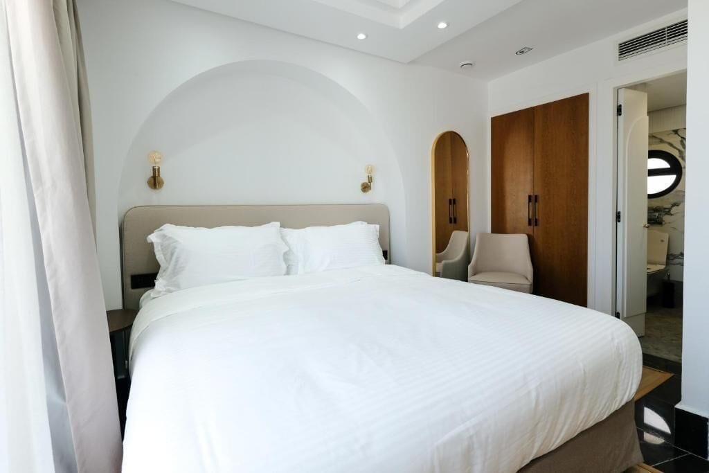 Deluxe Double Room, City View | Minibar, in-room safe, iron/ironing board, free cribs/infant beds