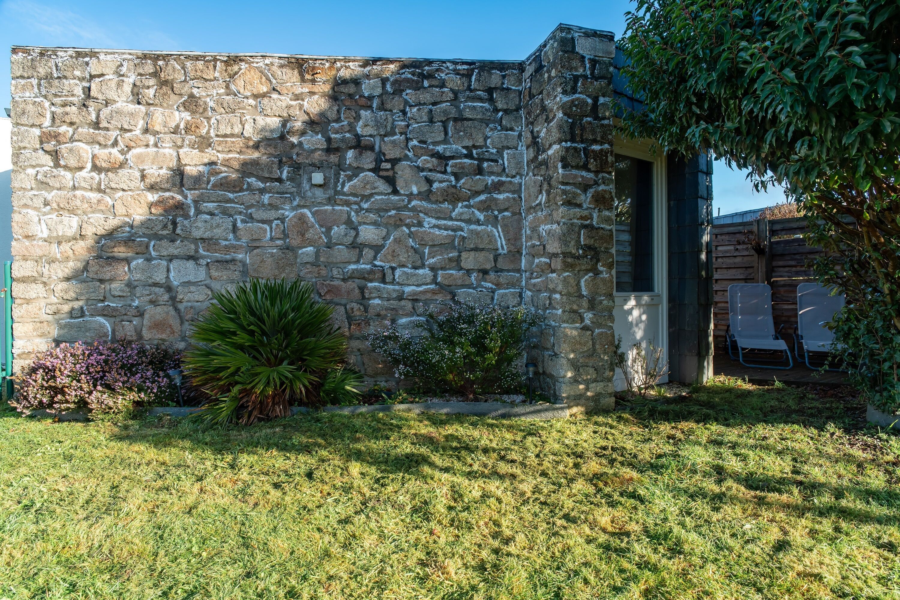 A stone building with a small garden area in front.
