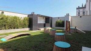 A modern outdoor patio area with a small pool, seating, and a play structure. - w* | Amazing Loft w/ Balcony in Miraflores (Miraflores)