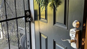 A door with a keypad lock, a mesh screen, and a keyhole. - Cozy Apartment in Superb Fort Washington MD-Private Keyless Entry. (Fort Washington)