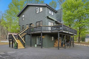 A two-story house with a balcony and a staircase leading to the upper floor.