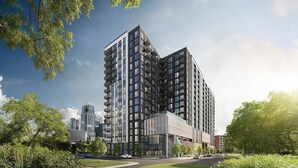 A modern high-rise building with multiple balconies, surrounded by greenery and other buildings. - Landing | Spectacular 1BD in Uptown Charlotte (Charlotte)