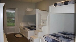 A bedroom with bunk beds, a ceiling fan, and a window with blinds. - POC 4 Bedroom, 3 bath Barndominium close to Froggies and 5D (Port Lavaca)