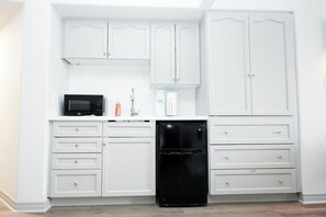 Microondas, cafetera y tetera, utensilios de cocina y comedor 