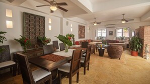 A spacious living area with a dining table, chairs, sofas, and potted plants. - Best location; magical 4BR house w/ large pool (Cartagena de Indias)