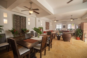 A spacious living area with a dining table, chairs, sofas, and potted plants. - Best location; magical 4BR house w/ large pool (Cartagena de Indias)