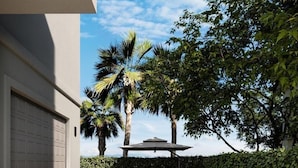 A swimming pool with a view of palm trees and a clear sky. - H2O Living•Pool & Hot Tub•Game Room•Private Beach •Free Chair Service+Beach Gear (Miramar Beach)