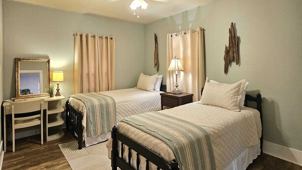 A bedroom with two beds, a desk, and a chair. - Lovely 2-bedroom downtown apartment in charming Lafayette (Lafayette)