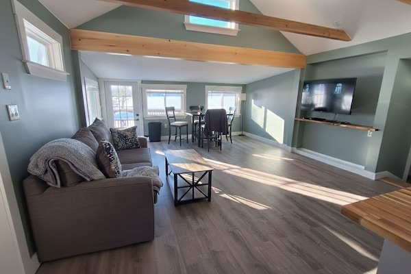 Living Room: Modern lakeside basecamp with clean lines and updated interior.