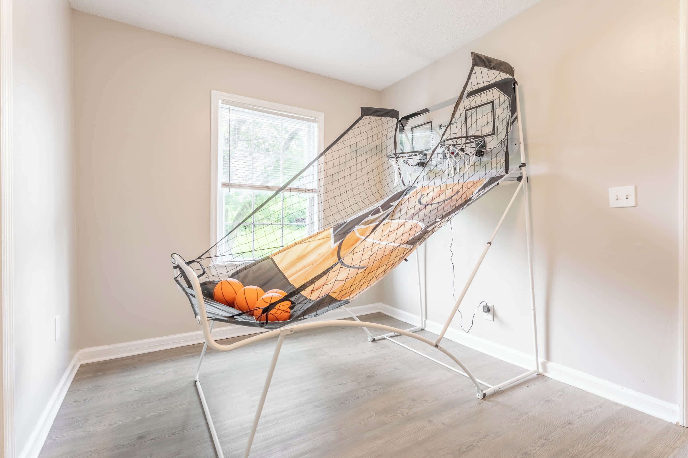 A room with a ceiling fan, a window, and a door.