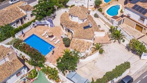 A residential area with a swimming pool, solar panels, and a road. - Villa La Ola - 200m from the beach (Benissa)