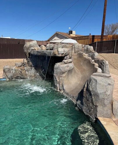Awesome pool home with rock waterslide, grotto, and waterfall.