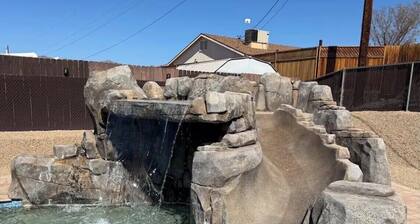 Awesome pool home with rock waterslide, grotto, and waterfall.