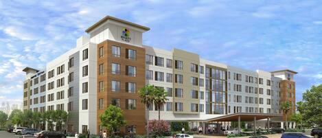 A multi-story hotel with a modern design, featuring a prominent logo at the top.