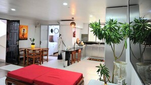 A modern interior with a dining area, a kitchenette, and a living space. - Lavish Lodge -2 Bedrooms 2 Bath (Suva)