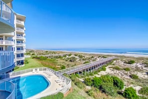 A multi-story hotel with a pool, beach access, and a pier. - Beautiful Oceanfront Getaway W/shared Pool, Central AC, Elevator, & W/D (Fernandina Beach)