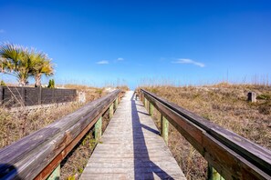 A wooden boardwalk leading through a natural area with dry grass and a clear blue sky. - Beachside Snowbird Escape With Fenced Yard & Washer/dryer - Walk to Beach Access (Jacksonville Beach)