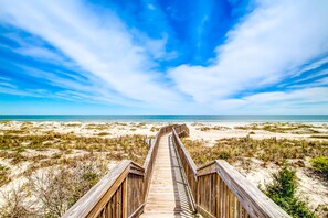 A wooden boardwalk leading to a beach with sand dunes and a clear blue sky. - Clean & Cozy Home With Oceanfront Views, Shared Pool, Free Wifi, Central AC (Fernandina Beach)