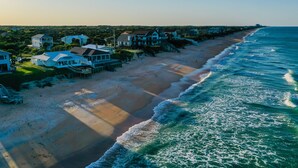 A coastal residential area with beachfront properties, including houses with balconies and a sandy beach. - Beachfront Home w/ Private Lanai and Deck - Walk to the Beach (Flagler Beach)