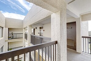 A multi-level building with balconies, a storage area, and a staircase. - Condo With Shared Pool, Beach Access and Spectacular Atlantic Ocean Views (Fernandina Beach)