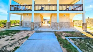 A two-story building with a covered walkway and a view of the surrounding landscape. - Coral Casa - Amazing Pool House Next to the Beach! 3 Min Walk! Awesome Pool! (Palm Coast)