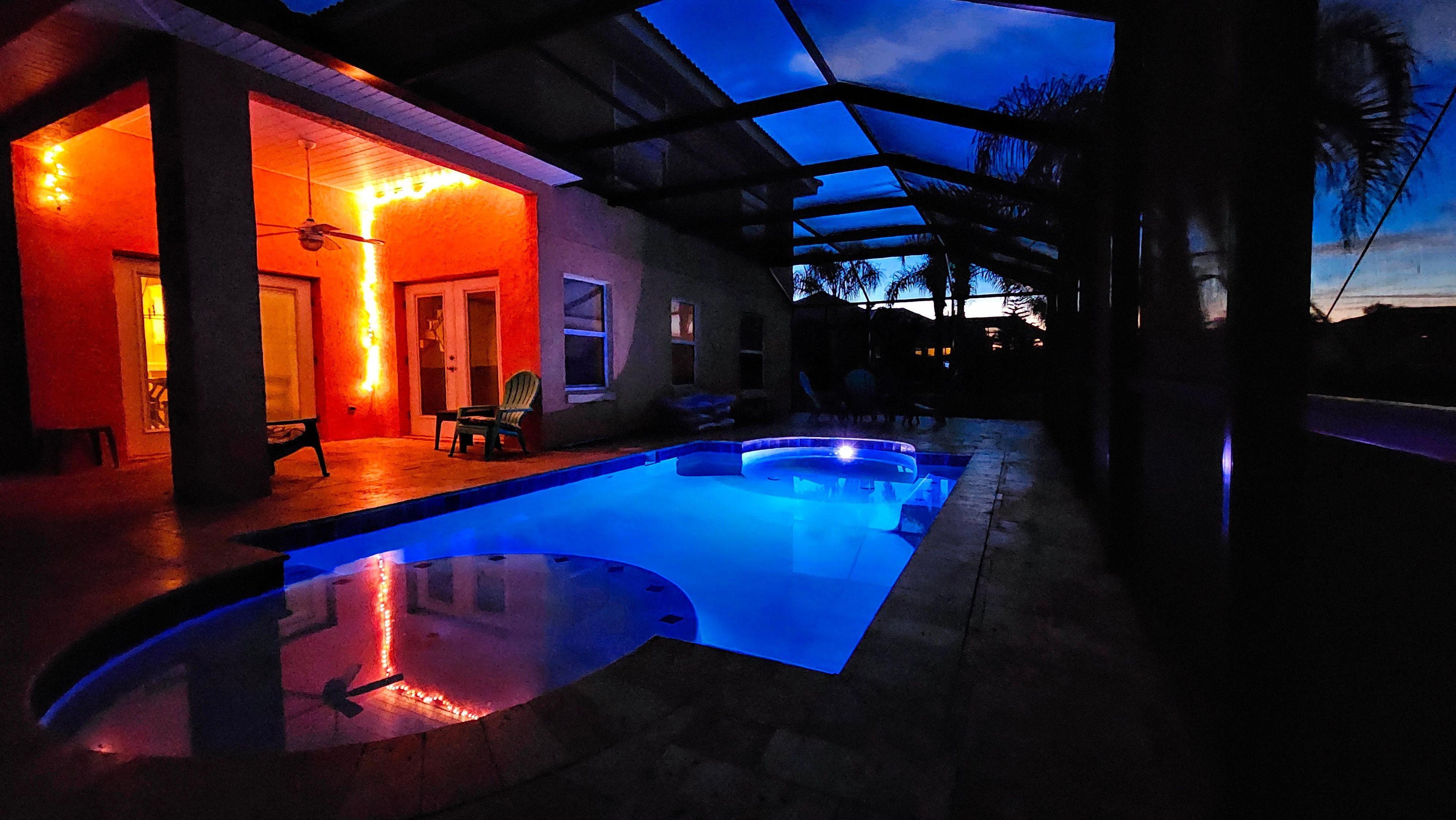 Ein Pool mit Glasüberdachung, eine überdachte Terrasse und Blick zum Himmel.