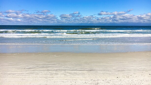 A beach with clear skies and waves. - A1A South St Augustine 2 Bedroom Oceanview Condo Sleeps 8 (St. Augustine)